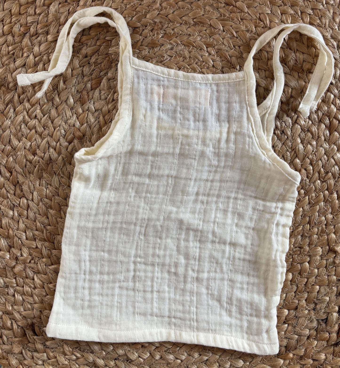 Close-up of newborn unisex easy wear top showcasing breathable muslin cotton fabric and simple design.