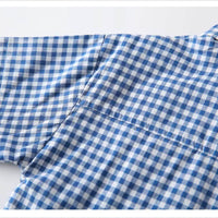 Three-quarter view of baby boy’s checked cotton shirt with matching tie – soft breathable finish