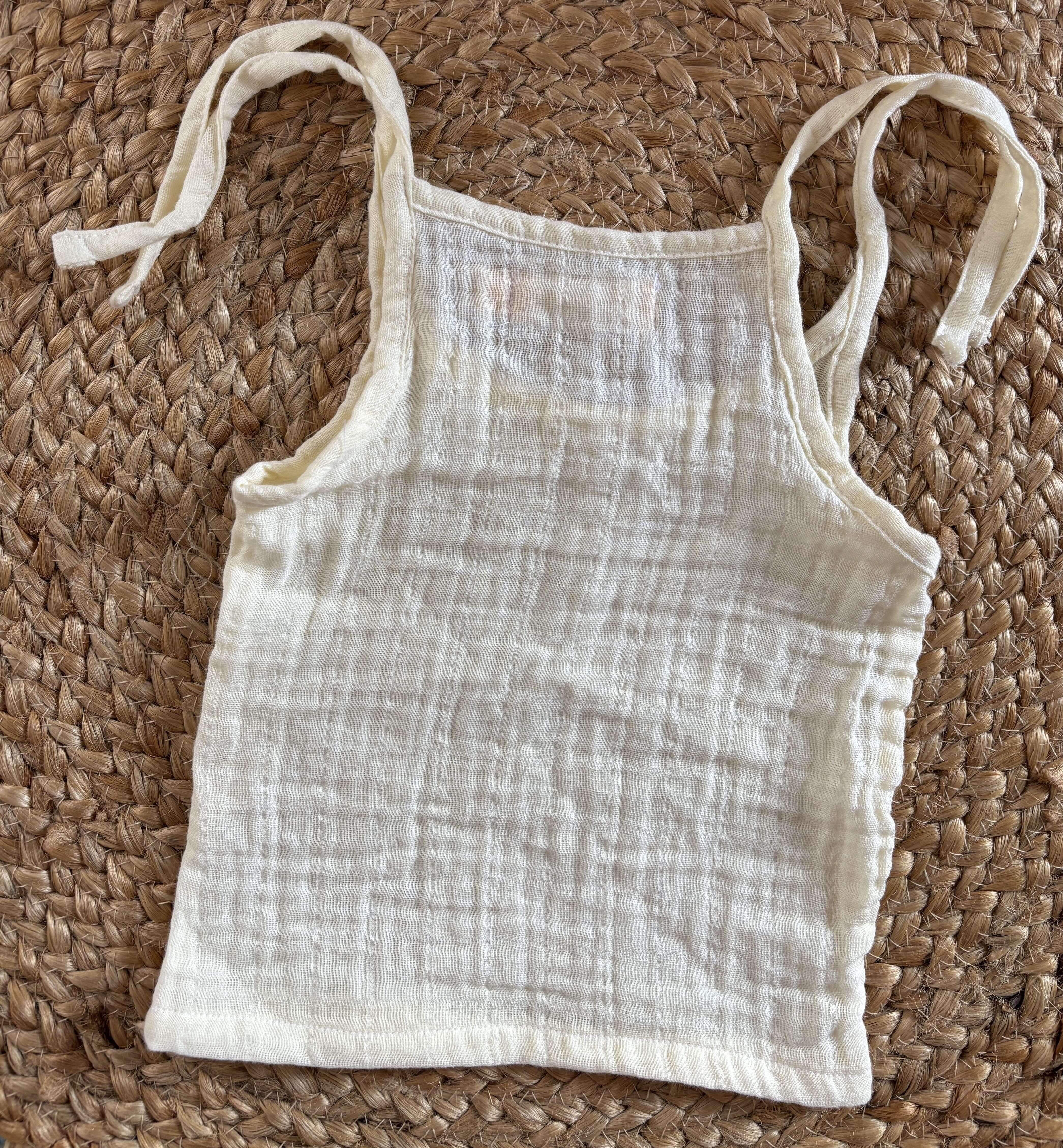 Close-up of newborn unisex easy wear top showcasing breathable muslin cotton fabric and simple design.